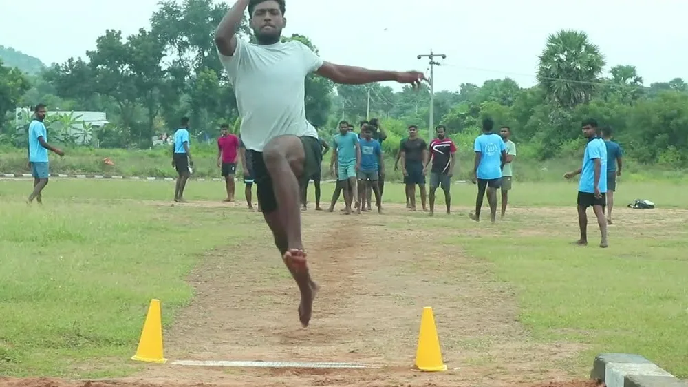 A student in the long jump pit during ground training